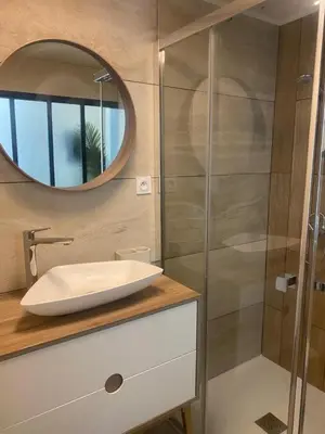 a bathroom with a sink and a mirror at A lombre du magnolia in LʼIsle-sur-la-Sorgue