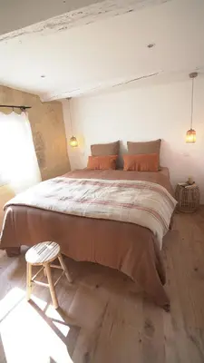 a large bed in a room with a wooden floor at La Maison des Lamanon in Salon-de-Provence