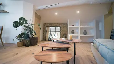 a living room with two tables and a couch at La Maison des Lamanon in Salon-de-Provence