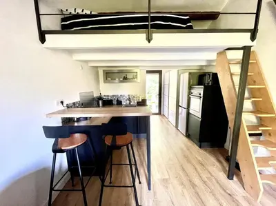 a kitchen with a bar with stools in a house at Ravissant appartement à 5min du centre ville d'Aix in Aix-en-Provence