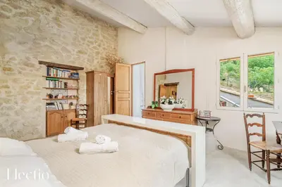 a bedroom with two beds and a mirror at Mas du Rocher I Electio in Puget
