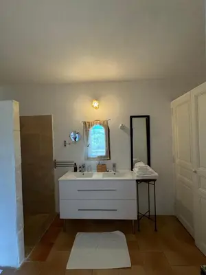 a bathroom with a white sink and a mirror at Chambre d'hôte au cœur de la Provence Eygalieres in Eygalières
