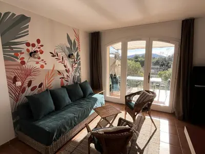 a living room with a green couch and chairs at Village Pont Royal en Provence - maeva Home - Maison climatisée 4 pièces 6 personnes - Sélection MAE-7054 in Mallemort