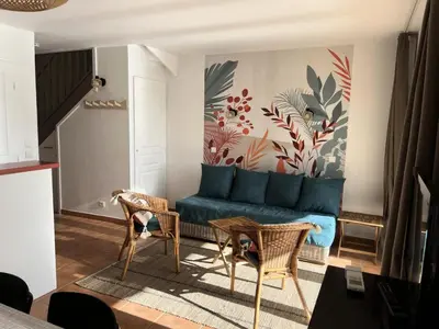 a living room with a blue couch and two chairs at Village Pont Royal en Provence - maeva Home - Maison climatisée 4 pièces 6 personnes - Sélection MAE-7054 in Mallemort