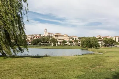 a park with a lake in front of a building at Village Pont Royal en Provence - maeva Home - Maison climatisée 4 pièces 6 personnes - Sélection MAE-7054 in Mallemort