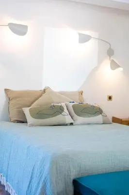 a bedroom with a bed with two pillows on it at Superbe Mas Authentique du Luberon Courroussouvo in Oppède