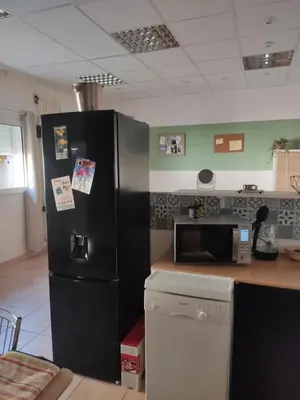 a kitchen with a black refrigerator and a microwave at Appartement Velleron-4 personnes in Velleron