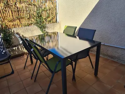 a table with four chairs sitting around it at Les oliviers in Ansouis