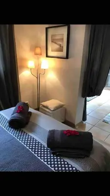 a bedroom with a bed with two pillows on it at Gîte de charme La Manola in Rognes