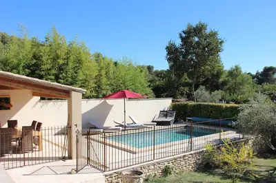 a villa with a swimming pool in a garden at Escapade en Provence, Gîte à Lagnes, Luberon, Vaucluse in Lagnes