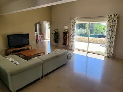 a living room with a couch and a television at Escapade en Provence, Gîte à Lagnes, Luberon, Vaucluse in Lagnes