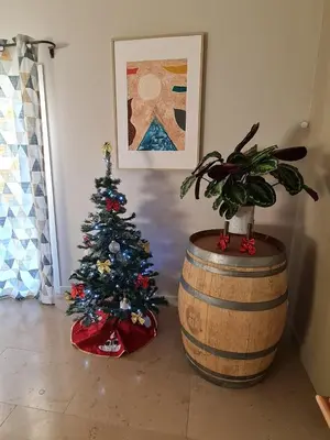 a christmas tree in a room next to a barrel at Escapade en Provence, Gîte à Lagnes, Luberon, Vaucluse in Lagnes