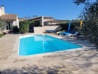 a swimming pool in front of a house at maisonnette avec piscine la picholine in Châteaurenard