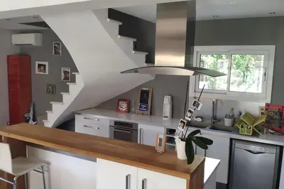 a kitchen with a staircase and a kitchen island at Maison avec piscine en Provence in Saint-Cannat
