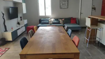 a living room with a wooden table and a couch at Maison avec piscine en Provence in Saint-Cannat