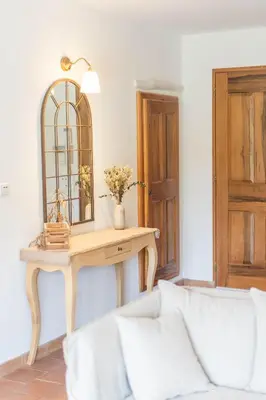 a room with a table with a mirror and a couch at Maison à 2 pas du Village D'ansouis à 30 Minutes D'aix-en-provence in Ansouis