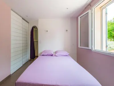 a large bed in a room with a window at Holiday Home in Vaucluse near Mont Ventoux in Pernes-les-Fontaines