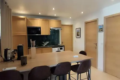 a kitchen with a large wooden table and chairs at Gîte Aux Bons Voisins in Gordes