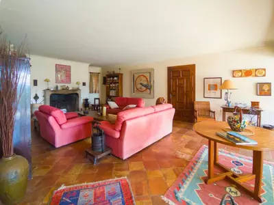 a living room with two pink couches and a table at Holiday Home La Tourelle des Ocres by Interhome in Roussillon