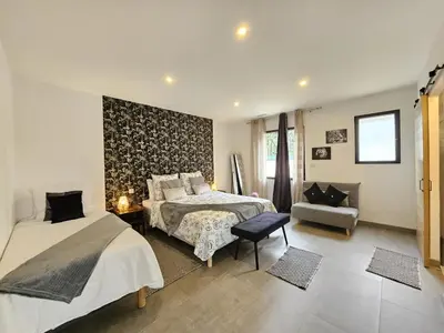 a bedroom with two beds and a chair at Villa lavandin in Apt