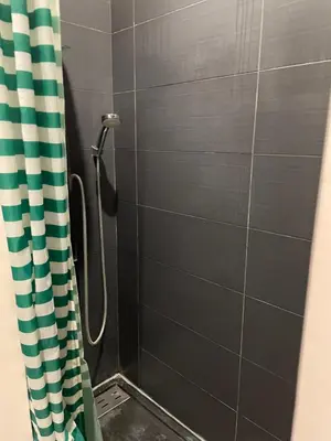 a shower with a shower curtain in a bathroom at VILLA NOUNOU in Le Thor