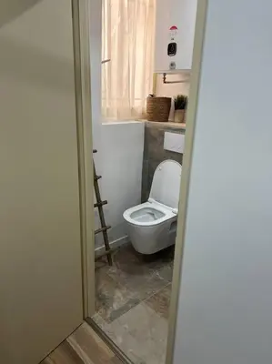 a bathroom with a white toilet and a window at Chambre Mignet in Aix-en-Provence
