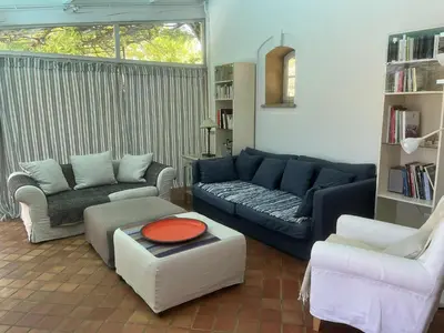 a living room with a blue couch and two chairs at Agréable maison de 65 m2 avec grande piscine in Aix-en-Provence
