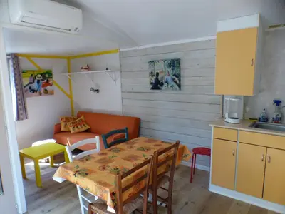 a kitchen and dining room with a table and a couch at TOSCANE in Saint-Rémy-de-Provence