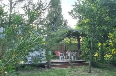 a table and chairs sitting on a porch in a garden at TOSCANE in Saint-Rémy-de-Provence