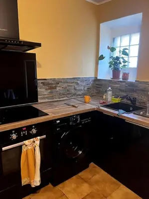 a kitchen with a washing machine and a sink at Village house of Jean in Gordes