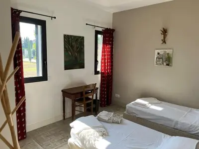 a bedroom with two beds and a desk and a window at Contemporary house 5mn away from Aix in the countryside in Aix-en-Provence