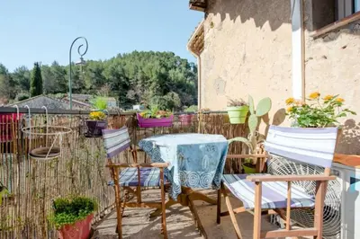 a patio with a table and chairs and a fence at Aude en Provence in Meyrargues