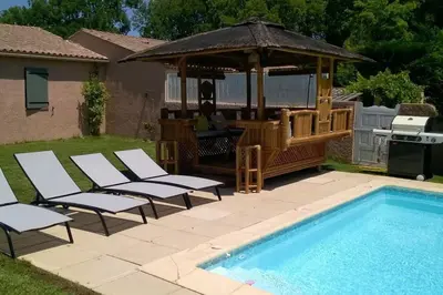 a pole in the grass next to a pool at Charming Villa with pool, close to city center in Aix-en-Provence