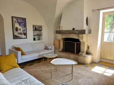 a living room with a couch and a fireplace at Magnifique Mas Provençal in Lauris
