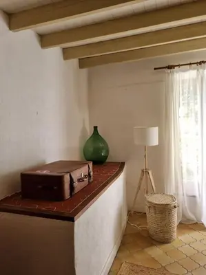 a room with a suitcase on a counter with a lamp at Magnifique Mas Provençal in Lauris