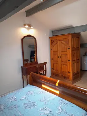 a bedroom with a bed and a dresser and a mirror at Mas La Gentille ,,, à la campagne , beautiful outdoor , swimming pool , pool house , Nice green Garden , BBQ ,,, only for you , pour passer un séjour inoubliable in Pernes-les-Fontaines