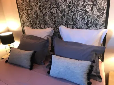 a group of pillows sitting on a couch in a room at Chambres d'hôtes La Manola in Rognes