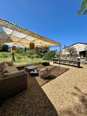 a patio with couches and a table and a table at Le Cabanon de Léandre in Meyrargues