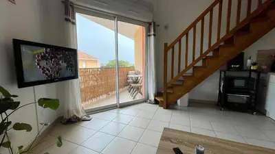 a living room with a staircase and a sliding glass door at ADDIS 2 in Salon-de-Provence