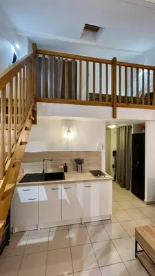 a kitchen with white cabinets and a staircase at ADDIS 2 in Salon-de-Provence