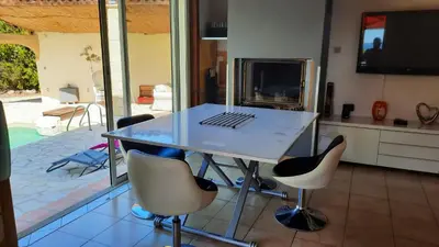 a white table with a laptop on it in a kitchen at Villa charmante à Mérindol avec piscine privée in Mérindol