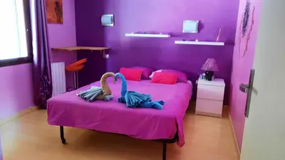 a pink bedroom with a bed with two stuffed animals on it at Villa charmante à Mérindol avec piscine privée in Mérindol