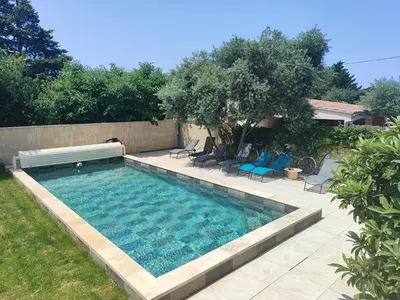 a swimming pool with chairs and a bench in a yard at Coeur de Provences in Saint-Didier