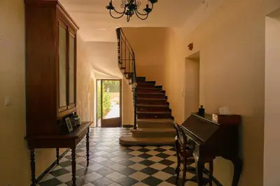 a hallway with a piano and stairs in a house at Coeur de Provences in Saint-Didier