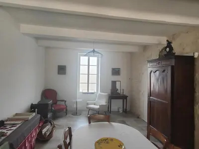 a living room with a table and chairs and a window at Coeur de Provences in Saint-Didier
