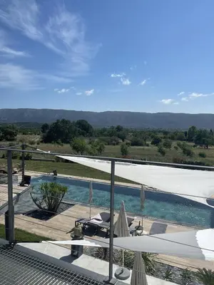 a view of a swimming pool with umbrellas at Les pins du Luberon in Coustellet