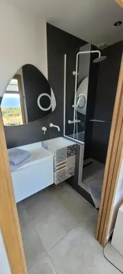 a small room with a bed and a mirror at Les pins du Luberon in Coustellet