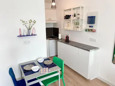 a small kitchen with a small table and chairs at Ma place au sud 1.08 in Éguilles