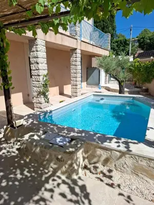 a swimming pool in the backyard of a house at Maison provençale rénovée in Pernes-les-Fontaines