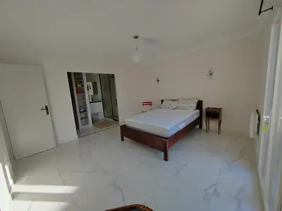 a bedroom with a bed in a white room at Maison provençale rénovée in Pernes-les-Fontaines